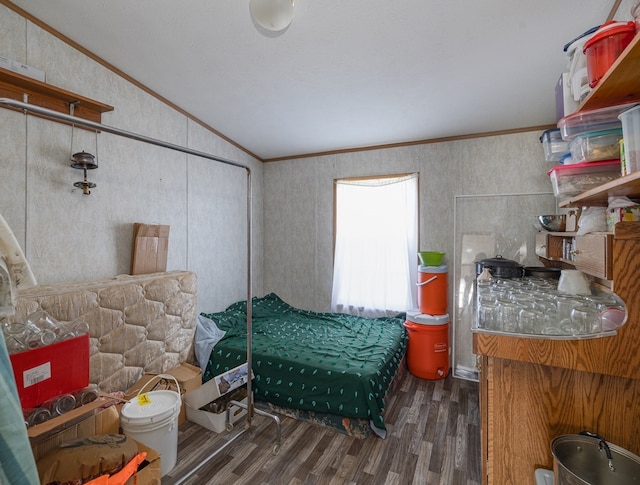 bedroom featuring ornamental molding, dark wood-type flooring, and lofted ceiling