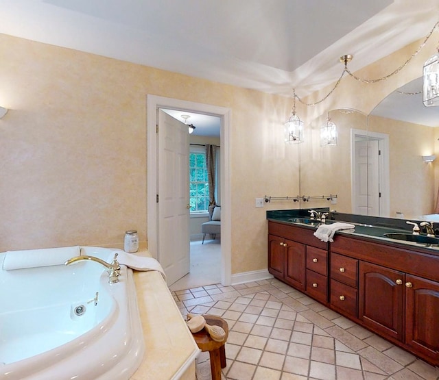 bathroom with vanity, tile patterned flooring, and a bathing tub