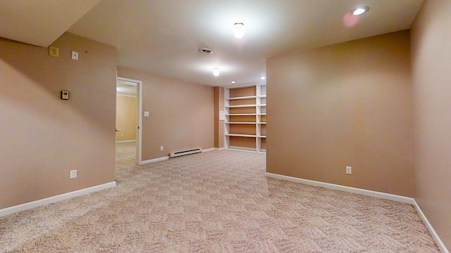 unfurnished room with light colored carpet and a baseboard heating unit