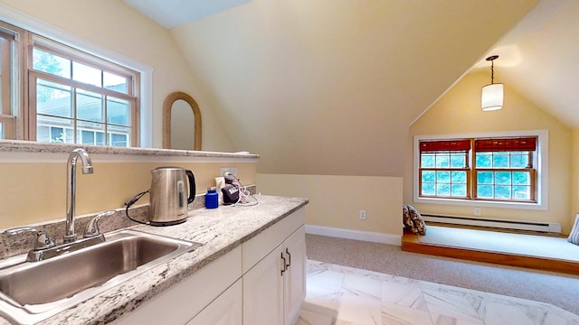 bathroom with sink, vaulted ceiling, a healthy amount of sunlight, and a baseboard heating unit