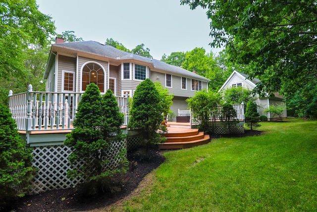 back of house featuring a yard and a deck