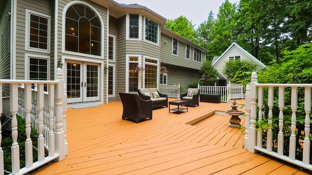 wooden deck featuring outdoor lounge area and french doors