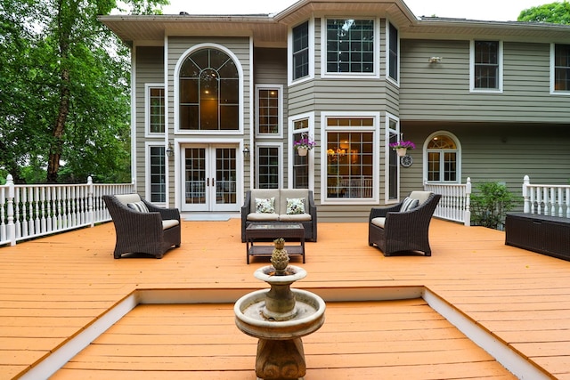 wooden terrace with french doors and an outdoor hangout area