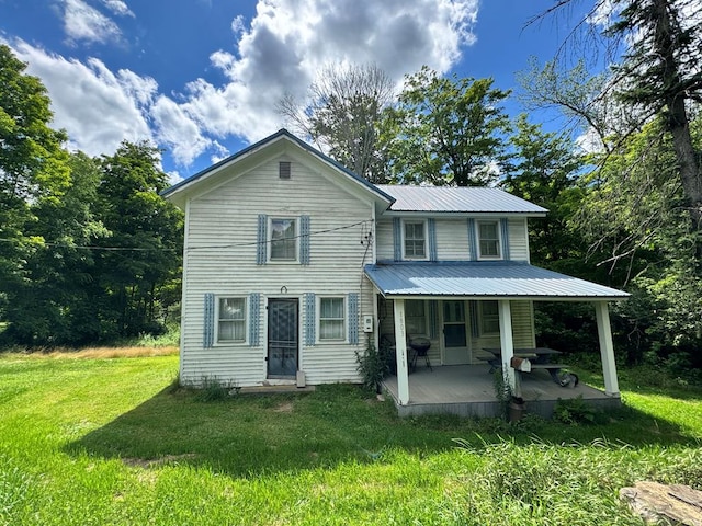 view of front of property with covered porch and a front lawn