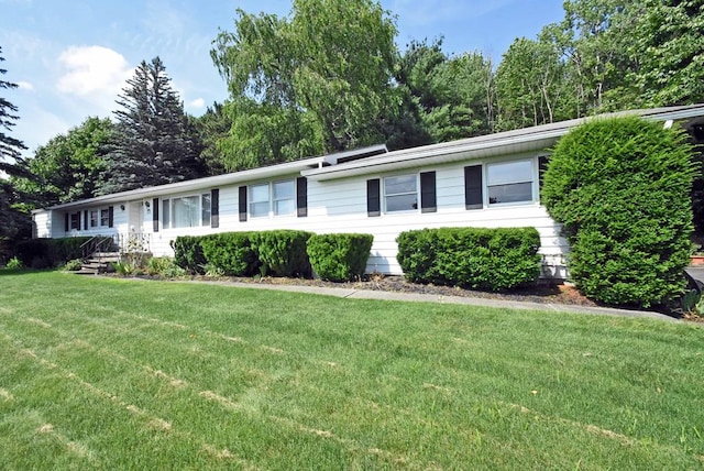 ranch-style home featuring a front yard