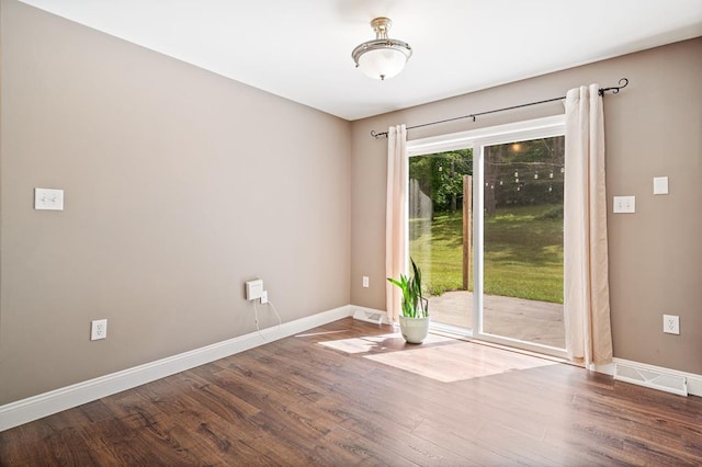 unfurnished room with hardwood / wood-style flooring