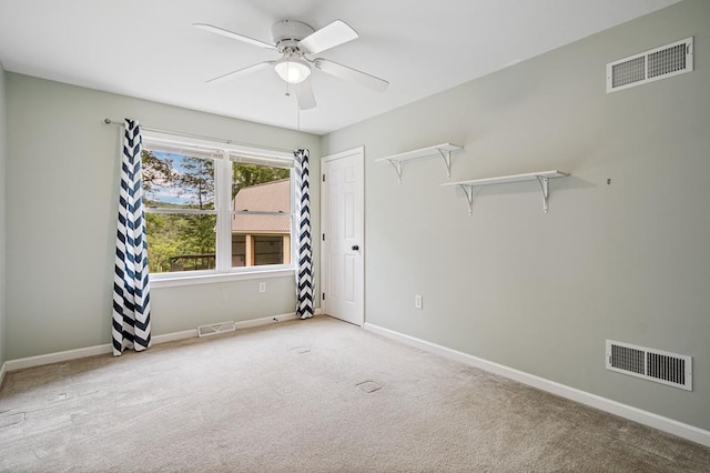 spare room with carpet flooring and ceiling fan