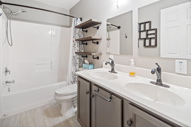 full bathroom featuring shower / bath combination with curtain, vanity, and toilet