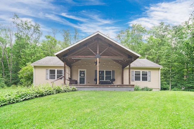 rear view of property with a yard