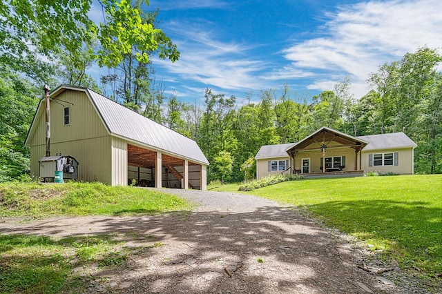 view of front of property with a front lawn and an outdoor structure