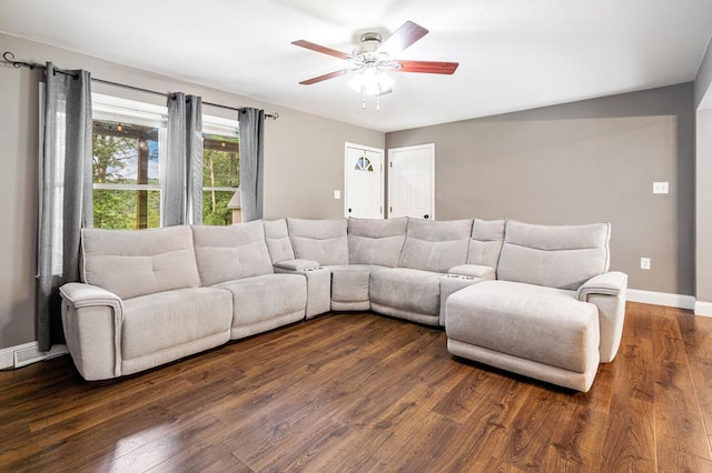 living room featuring ceiling fan and dark hardwood / wood-style floors