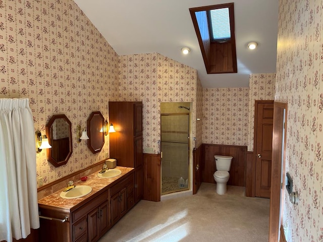 bathroom featuring vanity, lofted ceiling, toilet, and walk in shower