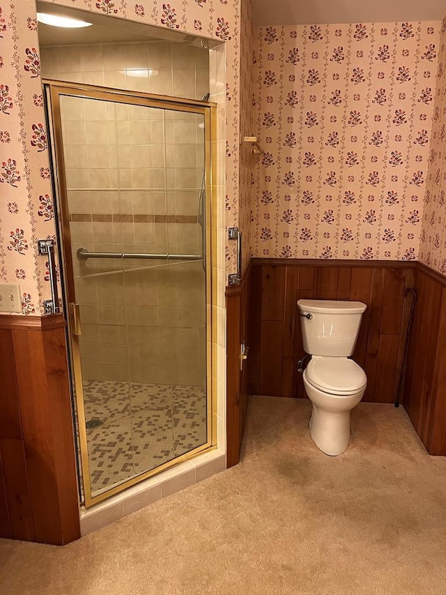 bathroom with a shower with door and toilet