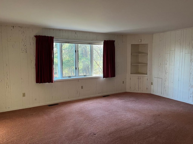 empty room with carpet floors and built in features