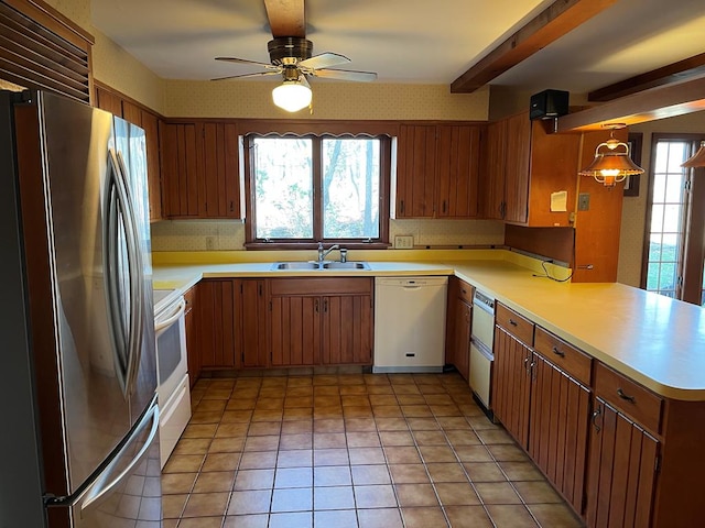 kitchen with pendant lighting, sink, ceiling fan, kitchen peninsula, and white appliances