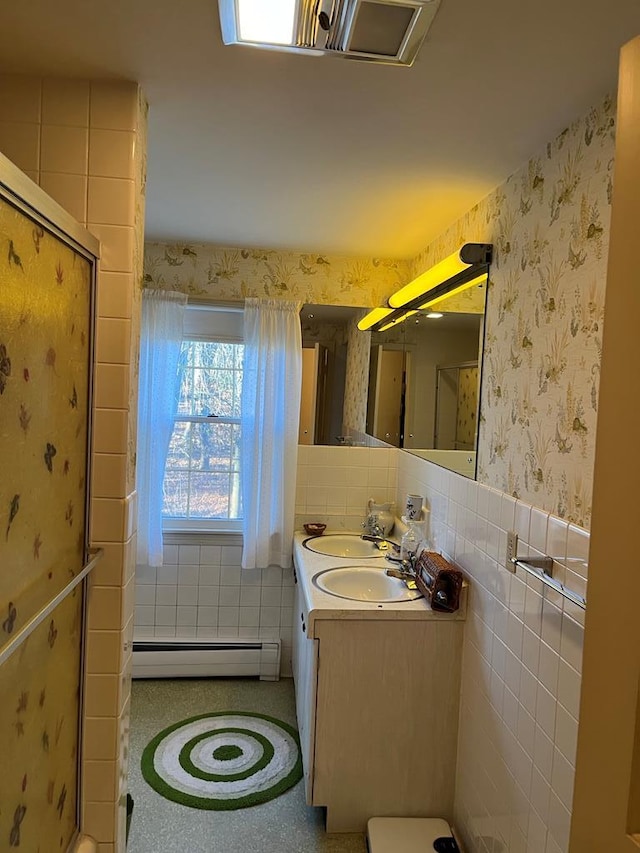 bathroom featuring a baseboard radiator and vanity