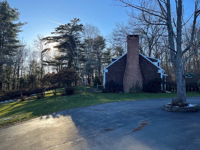 view of side of home with a lawn