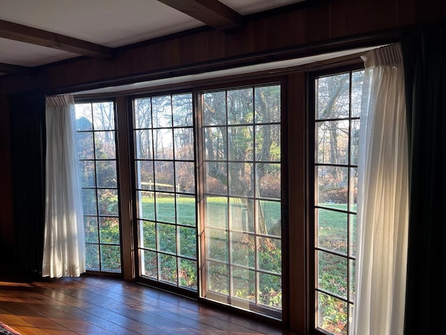 entryway with dark wood-type flooring and beamed ceiling