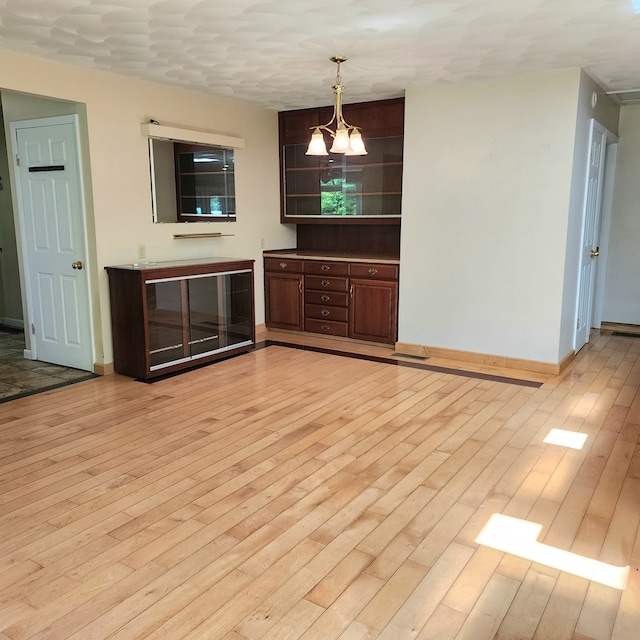 interior space featuring light hardwood / wood-style floors and an inviting chandelier