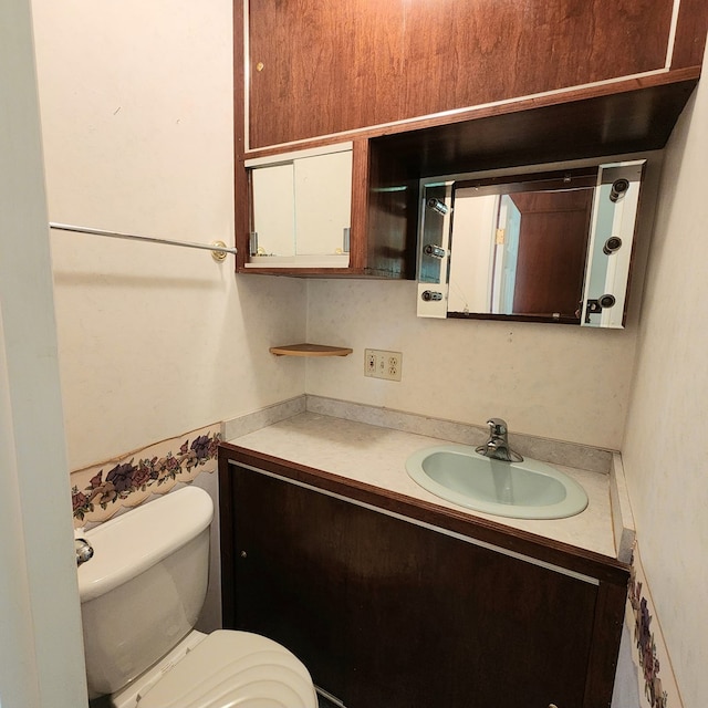 bathroom featuring vanity and toilet