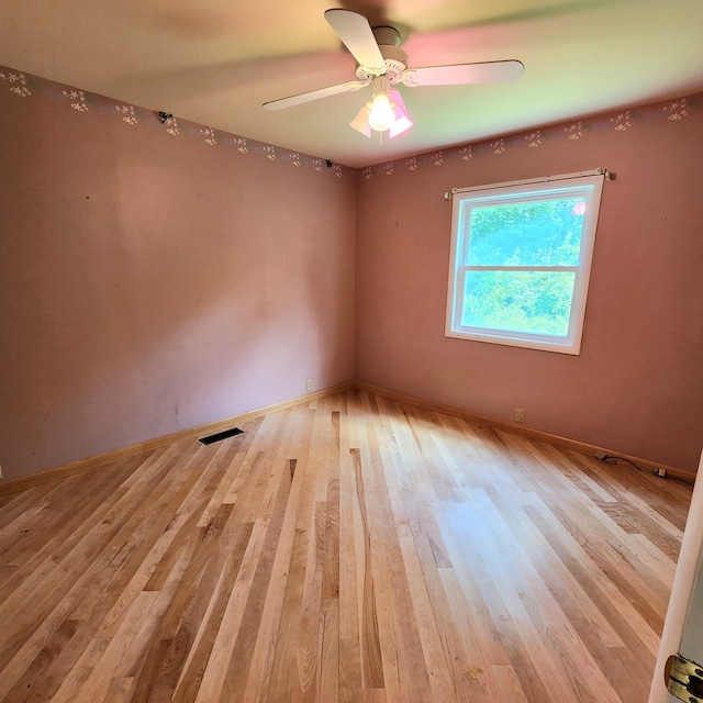 spare room featuring ceiling fan and light hardwood / wood-style floors