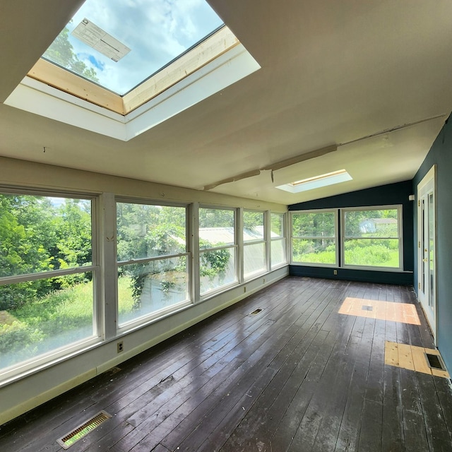 unfurnished sunroom with lofted ceiling with skylight