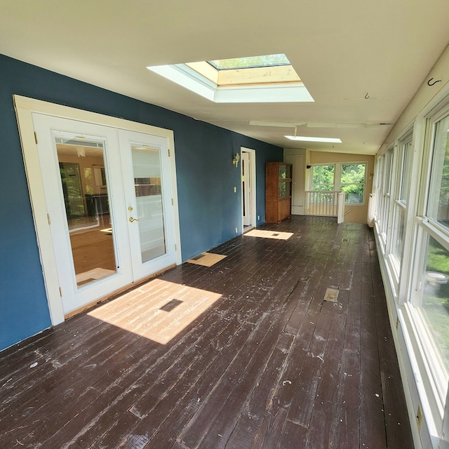 unfurnished sunroom featuring french doors and lofted ceiling with skylight