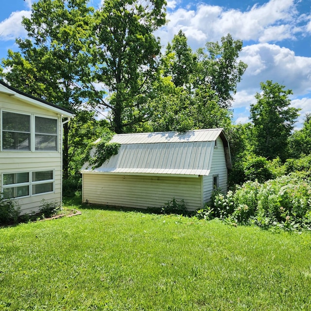 view of outbuilding with a lawn