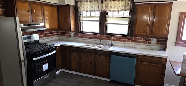 kitchen with extractor fan, decorative backsplash, dark hardwood / wood-style flooring, sink, and stainless steel appliances