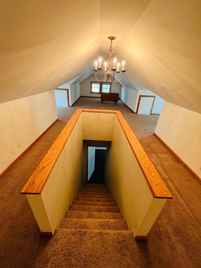 stairs with a notable chandelier, lofted ceiling, and carpet