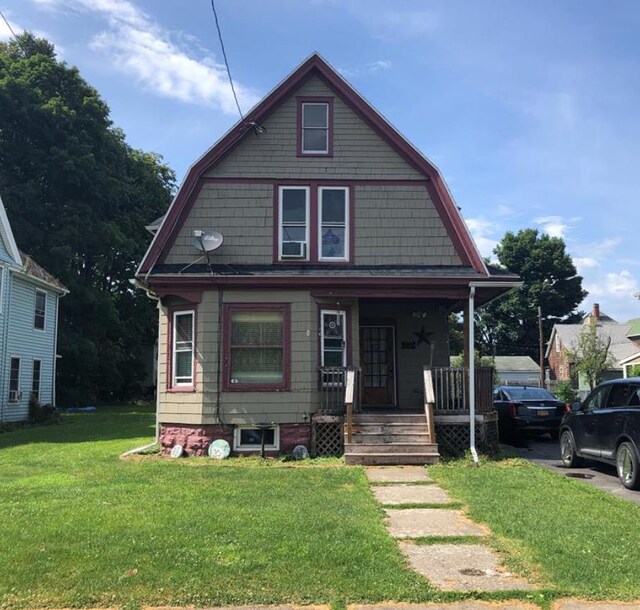 bungalow-style home with a porch and a front yard