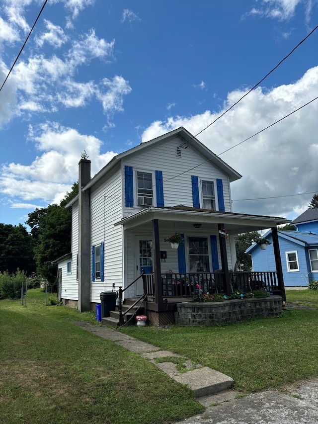 view of front of home featuring a front yard and a porch