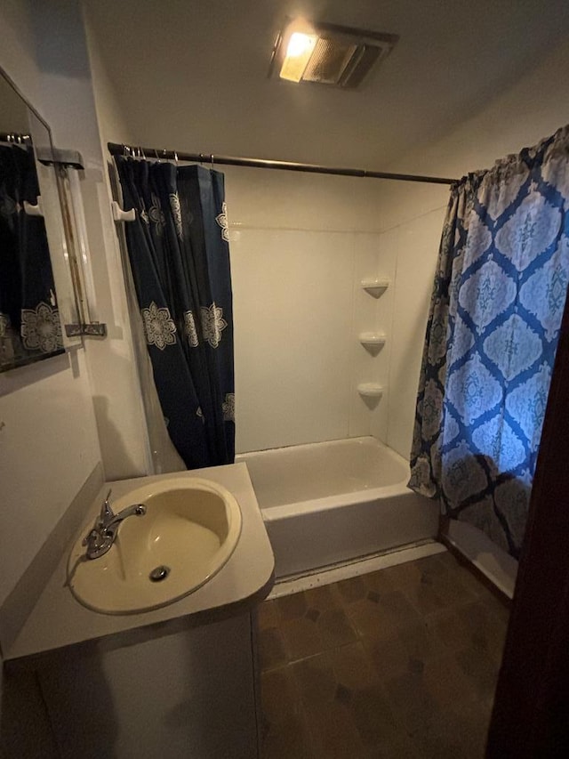 bathroom featuring vanity, shower / tub combo, and tile patterned flooring