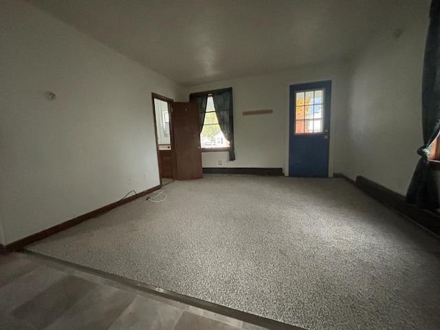 unfurnished living room with carpet floors and a healthy amount of sunlight