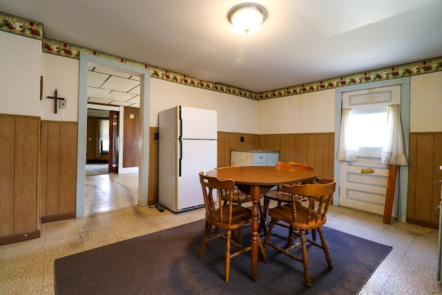 dining room with wooden walls