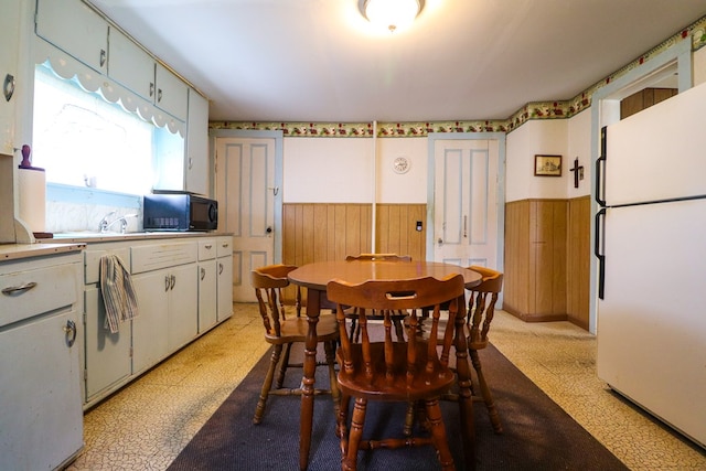 dining area featuring wooden walls