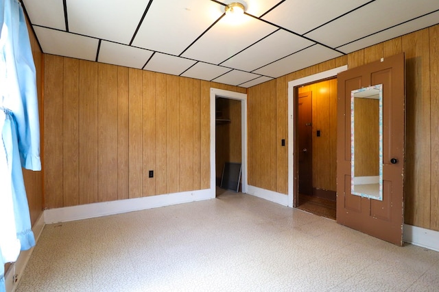 spare room featuring wood walls