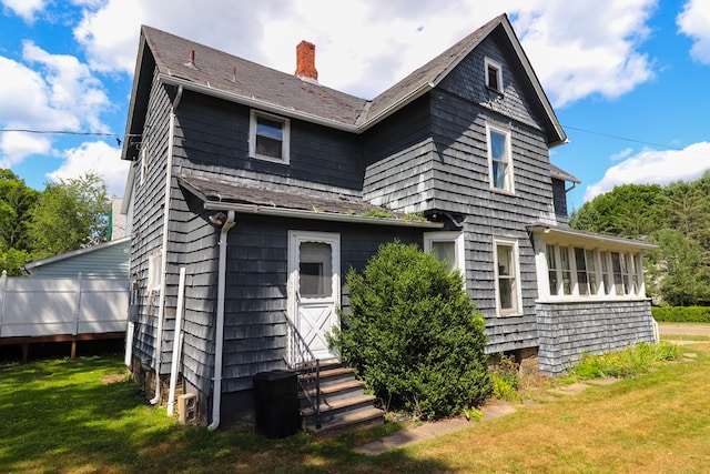 rear view of house with a lawn