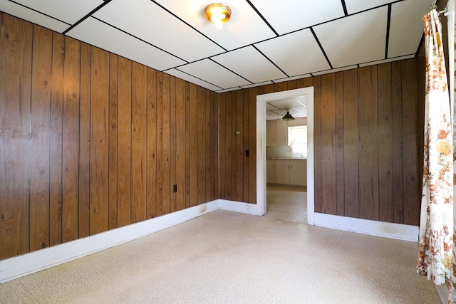 unfurnished room featuring wooden walls