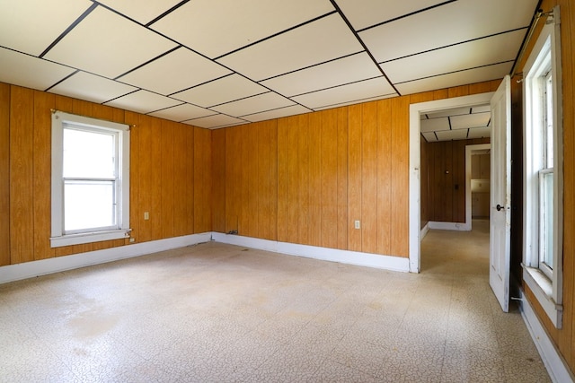 unfurnished room with wooden walls