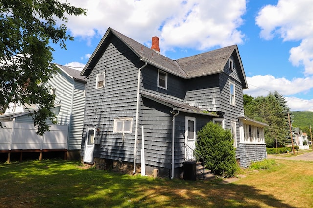 rear view of house with a yard