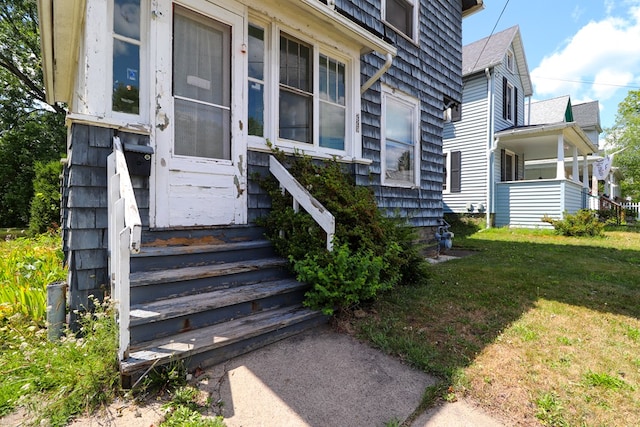 property entrance with a yard