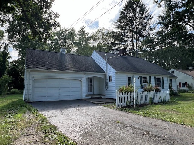 view of front of house with a front lawn and a garage