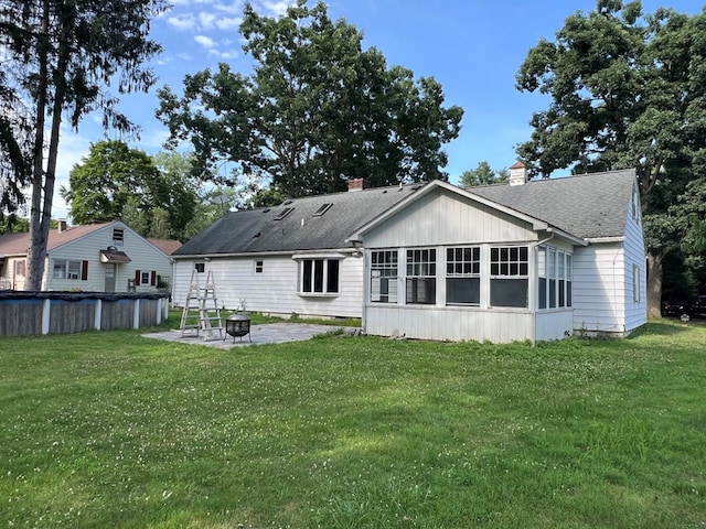 rear view of property with a lawn and a patio