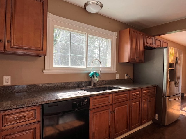 kitchen featuring dishwasher, stainless steel fridge, sink, and dark wood-type flooring