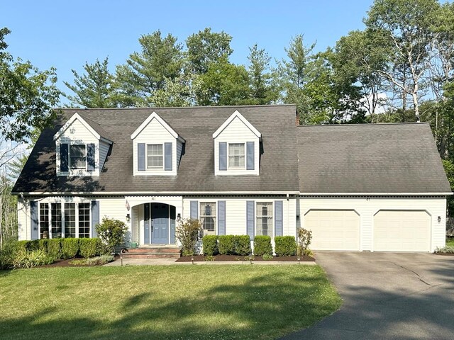 cape cod house with a front yard