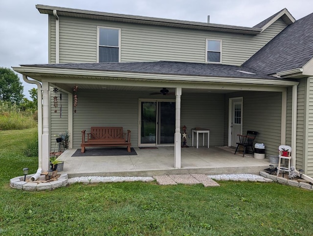 back of property featuring a lawn, a patio area, and ceiling fan