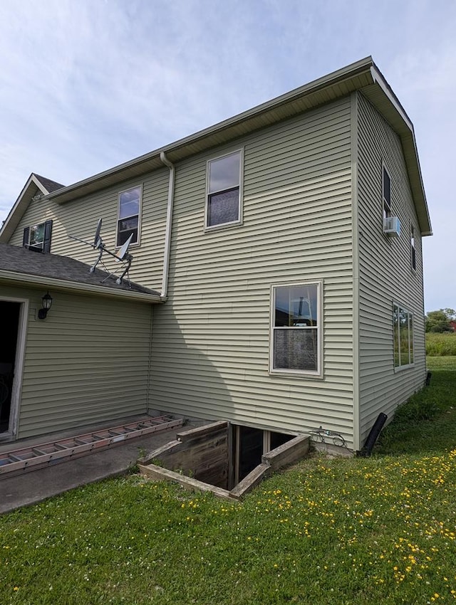 view of property exterior featuring a lawn and cooling unit