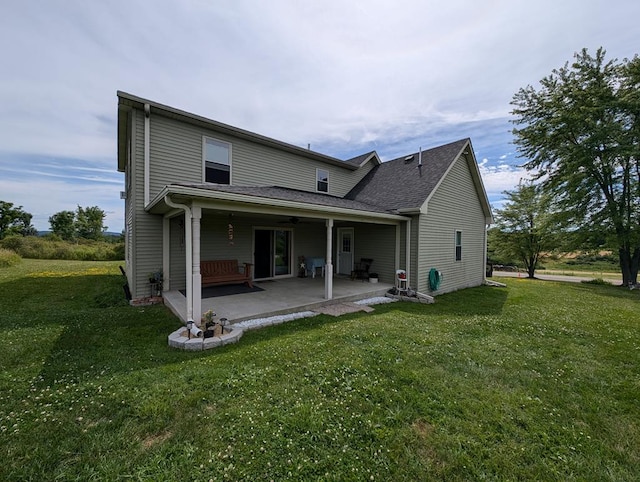 rear view of house featuring a yard and a patio