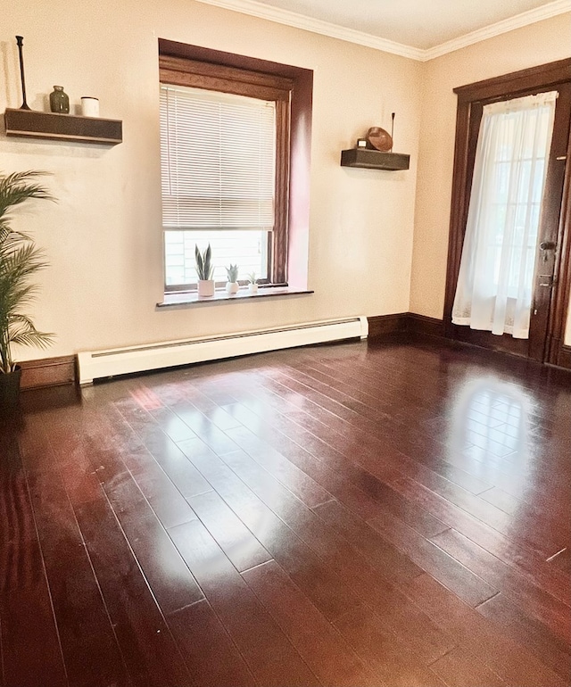 unfurnished room featuring baseboard heating, ornamental molding, and dark wood-type flooring